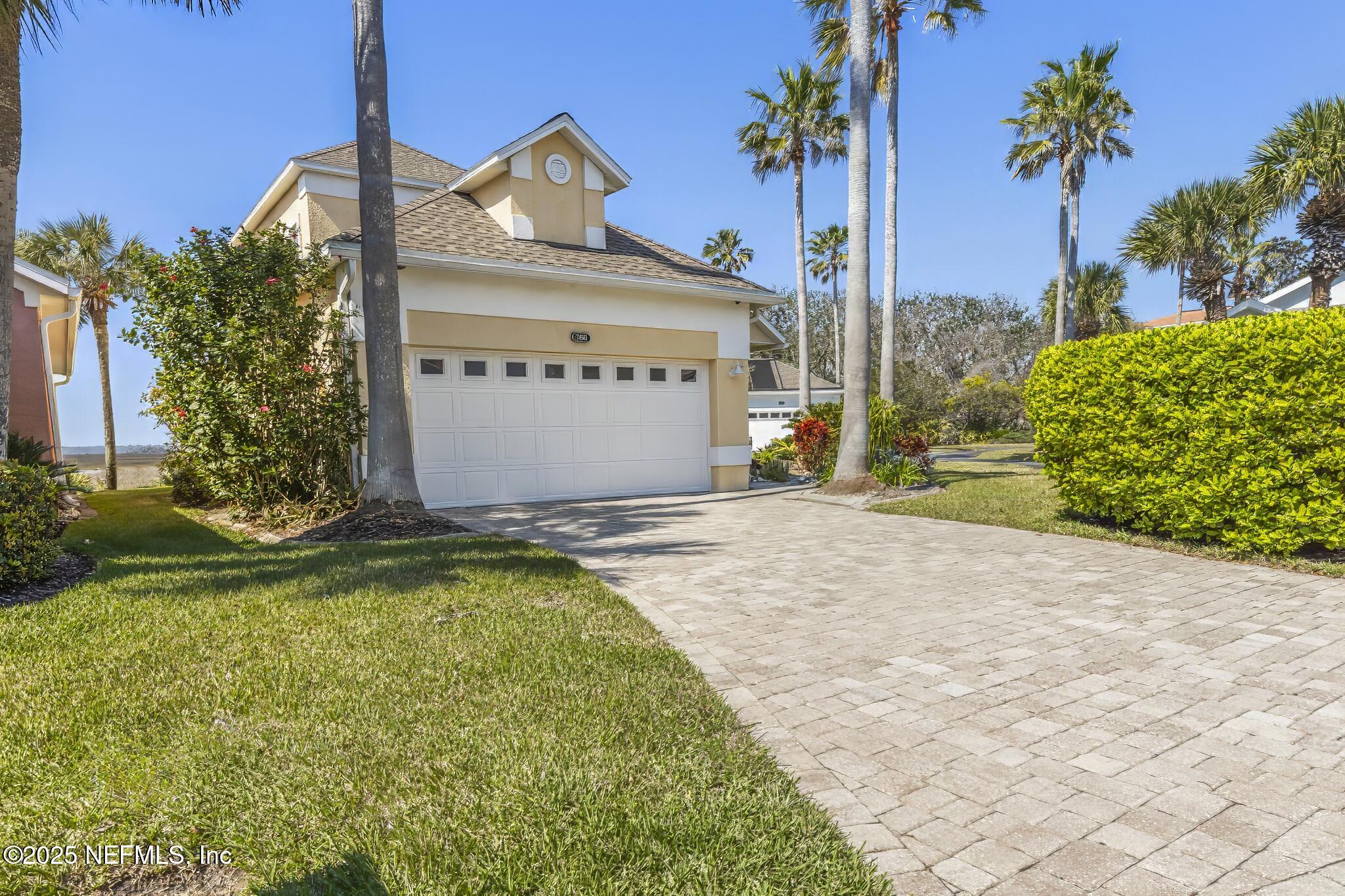 180 Kingston Drive St. Augustine, FL 32084 - Photo 42 of 55 a view of a house with a yard and potted plants