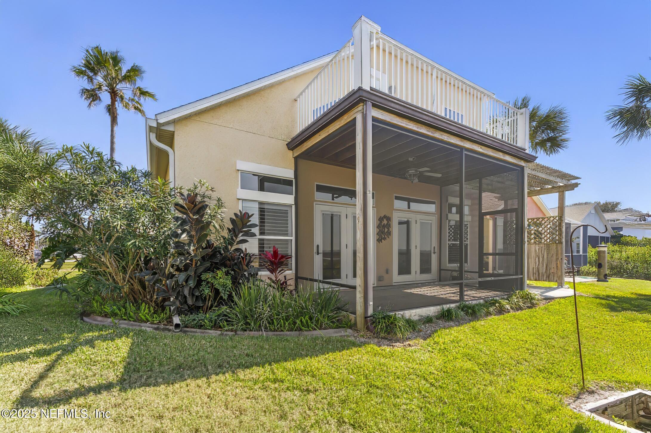 180 Kingston Drive St. Augustine, FL 32084 - Photo 44 of 55 a view of a house with small yard plants and palm trees