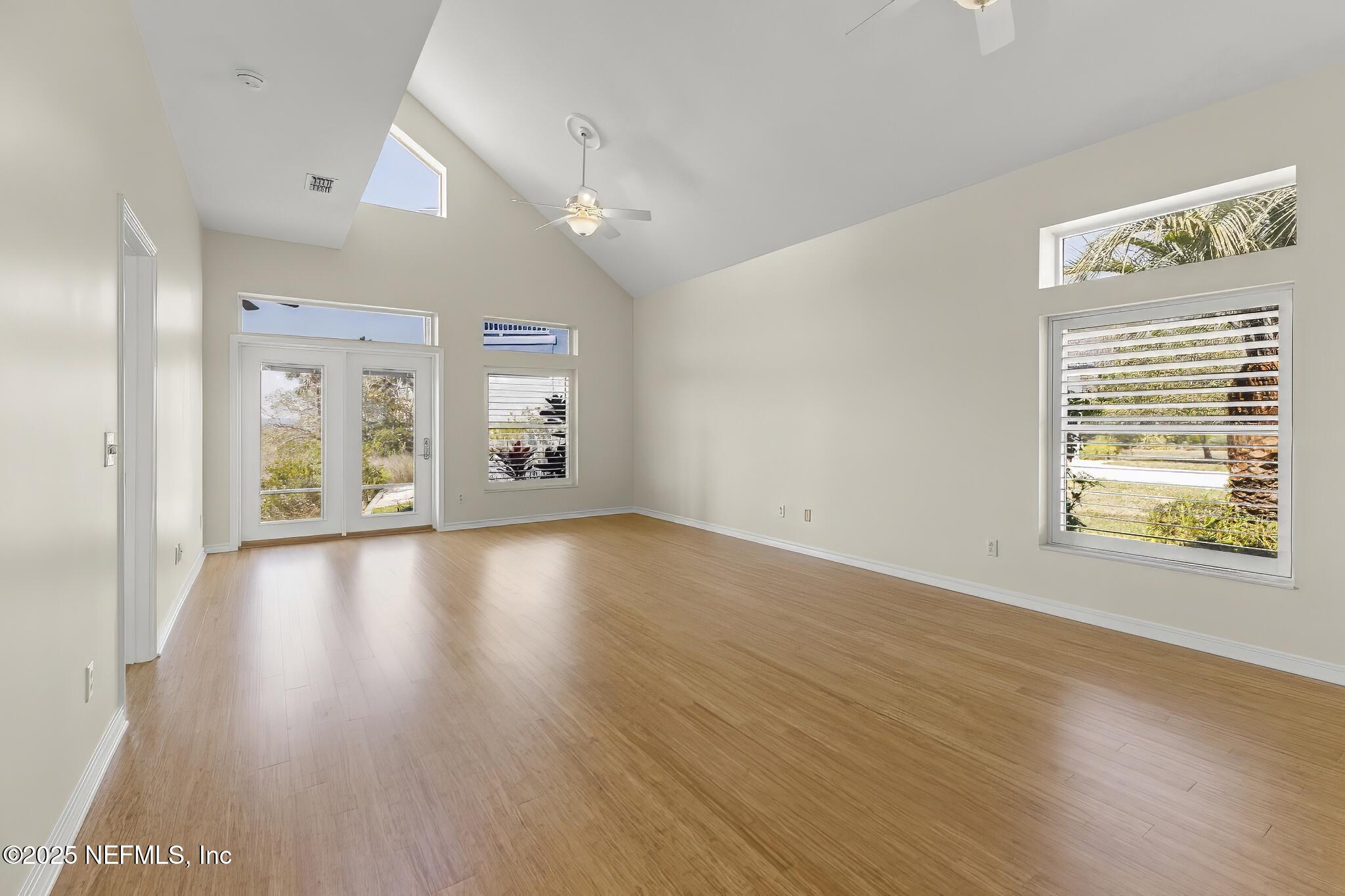180 Kingston Drive St. Augustine, FL 32084 - Photo 7 of 55 a view of an empty room with window and wooden floor
