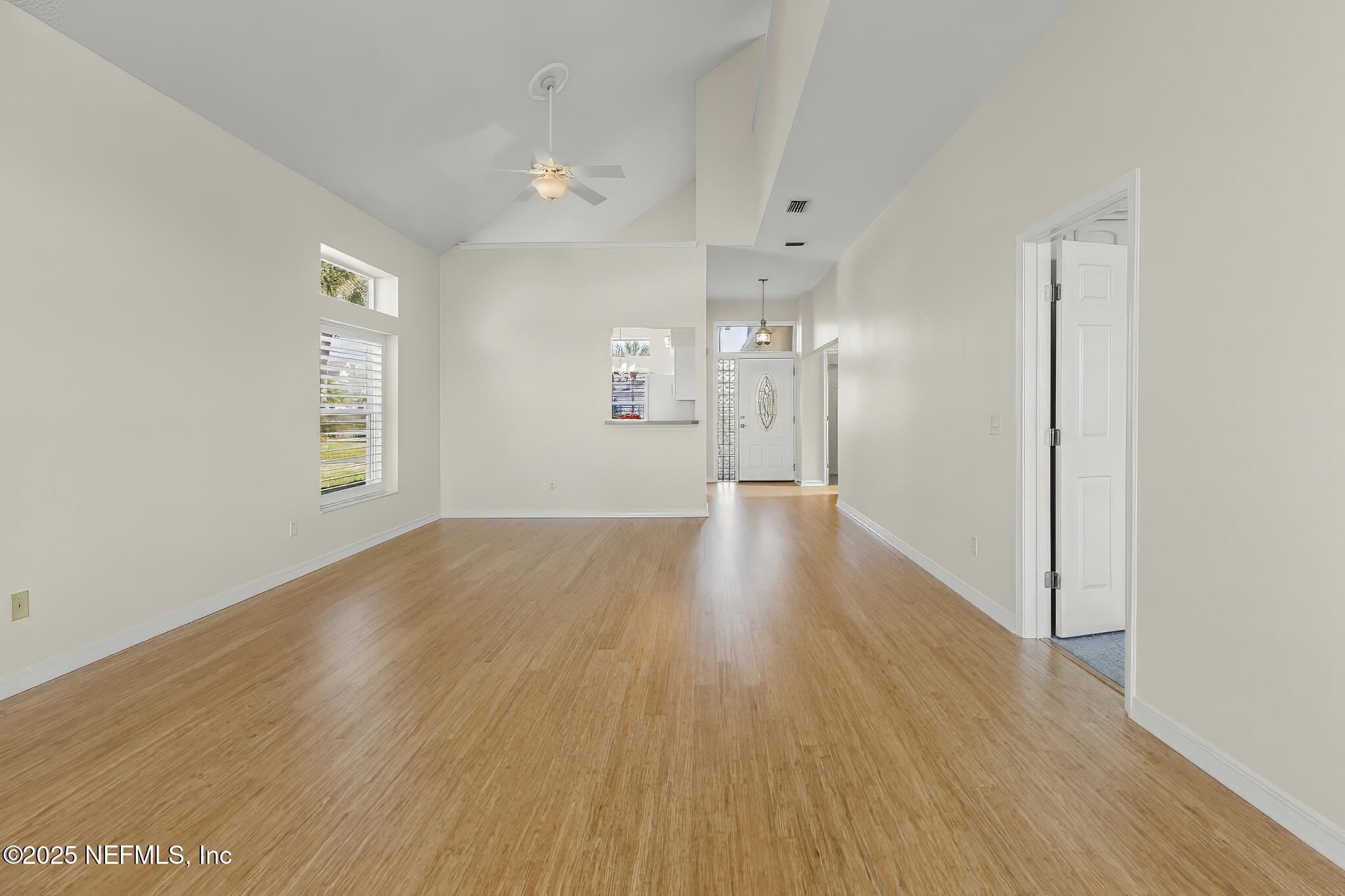 180 Kingston Drive St. Augustine, FL 32084 - Photo 9 of 55 a view of a big room with wooden floor and windows