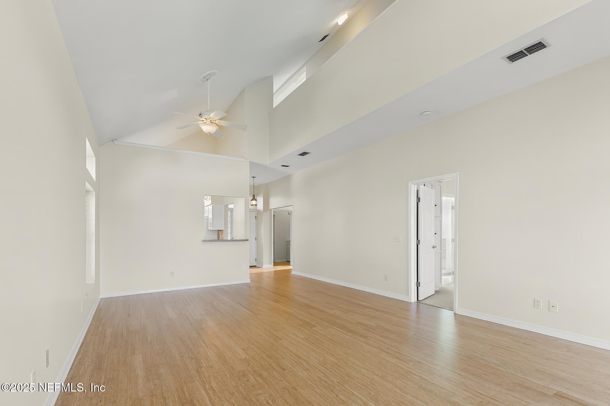 180 Kingston Drive St. Augustine, FL 32084 - Photo 10 of 55 a view of a big room with wooden floor and windows