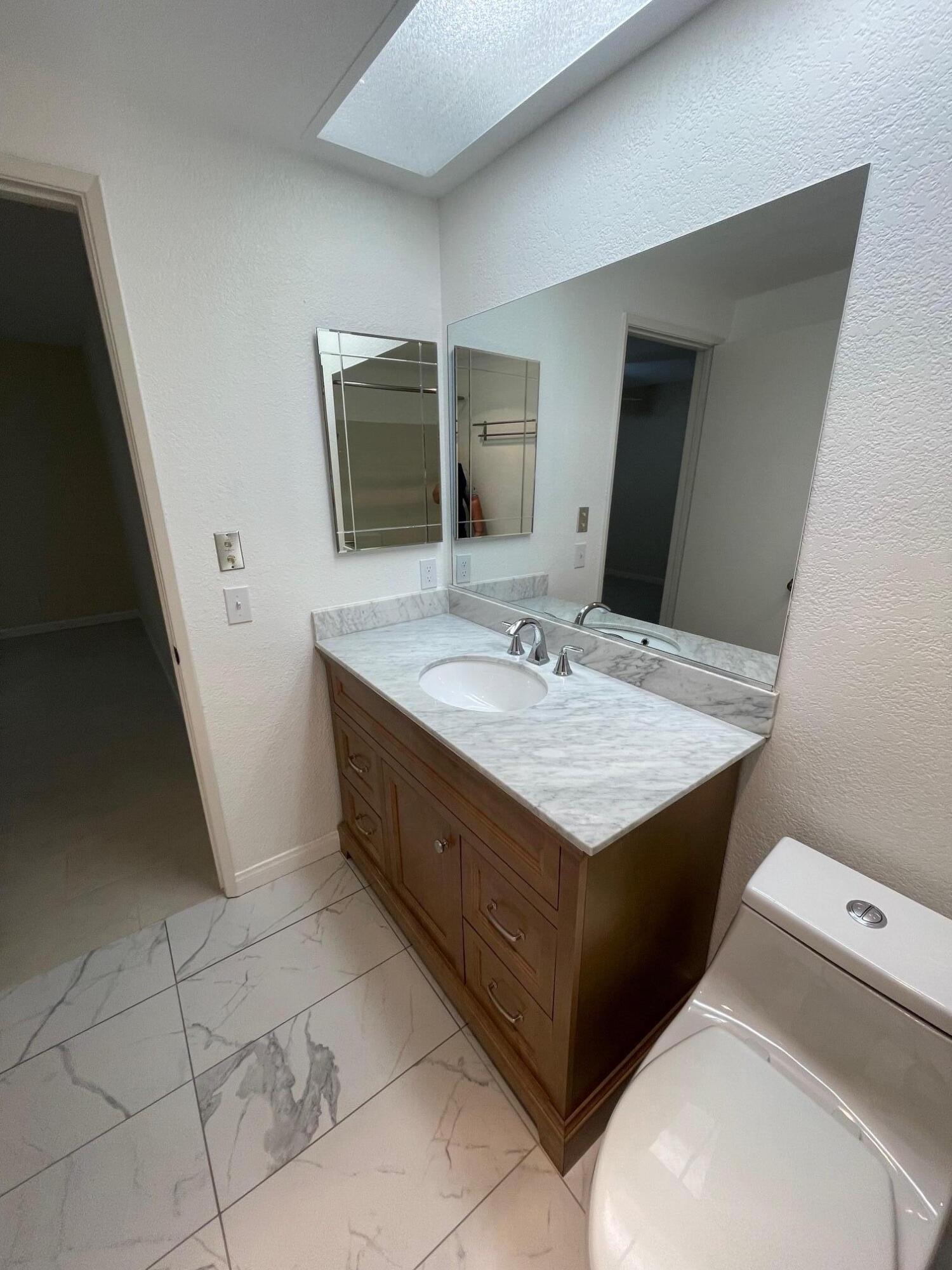 2700 Lawrence Crossley Road, Unit 4 Palm Springs, CA 92264 - Photo 11 of 18 a bathroom with a sink and a mirror