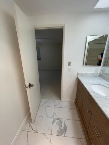 a bathroom with a double vanity sink and mirror