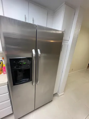 a stove top oven sitting inside of a kitchen