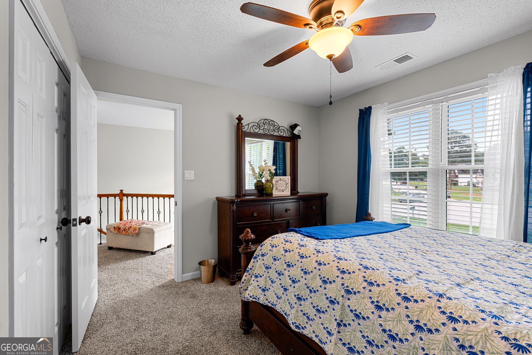 375 Gaelic Way Tyrone, GA 30290 - Photo 23 of 54 a bedroom with a bed and a chandelier