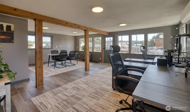 a living room with furniture a wooden floor and a large window