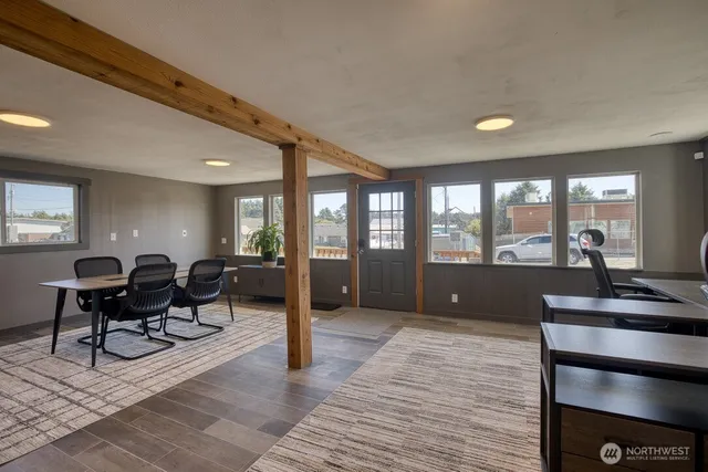 a living room with furniture a large window and rug