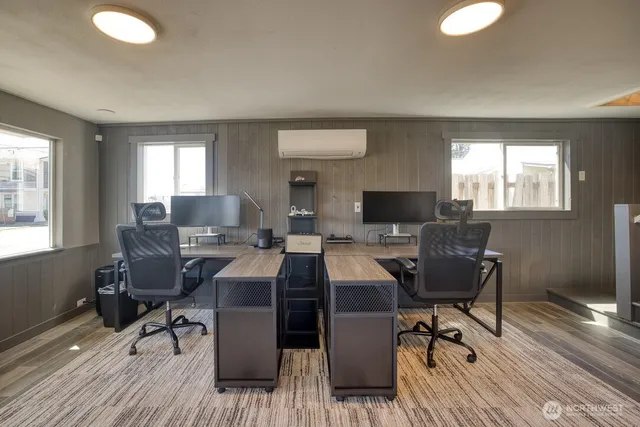 a view of a workspace with furniture and a window