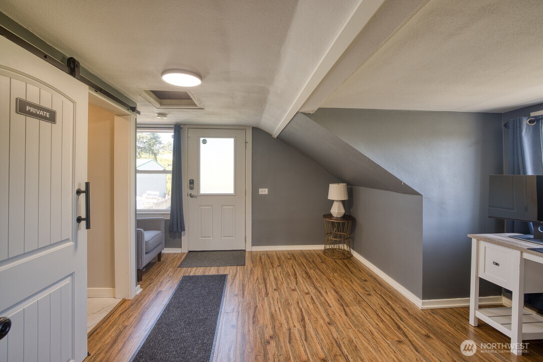 40 Main Street Pacific Beach, WA 98571 - Photo 24 of 40 a view of a hallway with wooden floor and staircase