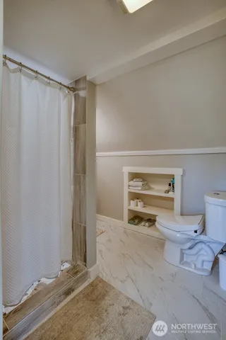 a room with a walk in closet and wooden floor