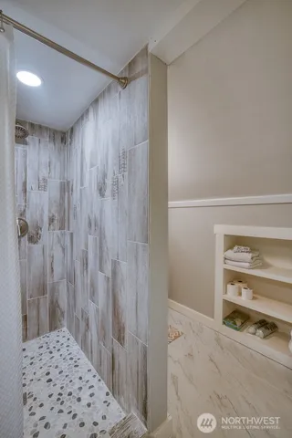 a bathroom with a shower and a sink