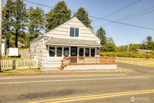 a view of a house with a patio and a yard