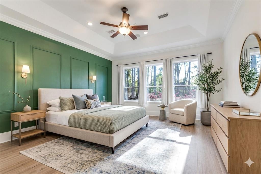 4111 Angling Lane Spring, TX 77386 - Photo 11 of 27 Bedroom with a decorative wall, ornamental molding, ceiling fan, light wood-type flooring, and a raised ceiling (Digital Staging Used)