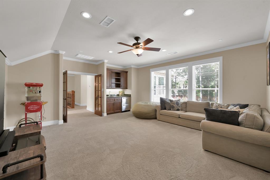 4111 Angling Lane Spring, TX 77386 - Photo 17 of 27 Living room with crown molding, light carpet, ceiling fan, recessed lighting, and vaulted ceiling