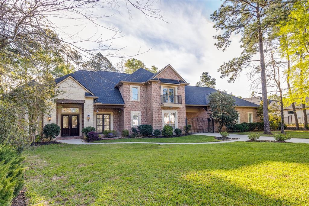 4111 Angling Lane Spring, TX 77386 - Photo 27 of 27 View of front facade with french doors, a front lawn, brick siding, a balcony, and roof with shingles