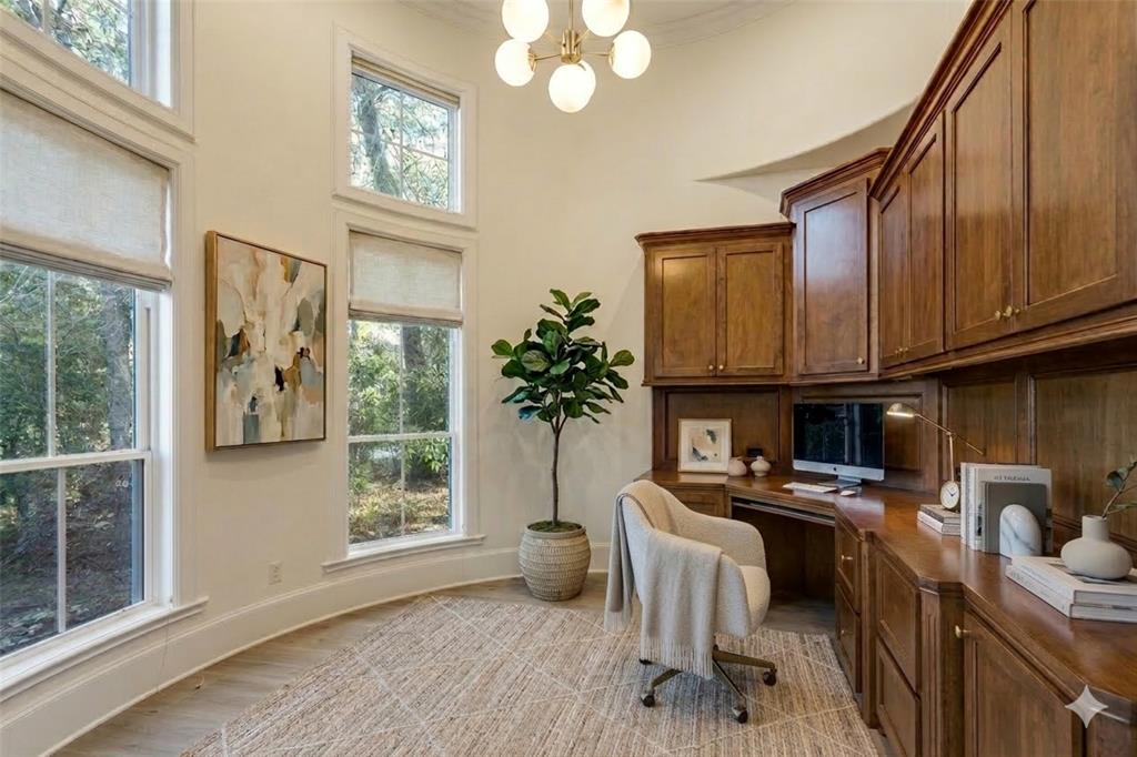 4111 Angling Lane Spring, TX 77386 - Photo 10 of 27 Office area with built in desk, light wood finished floors, suspended lighting, and a high ceiling (Digital Staging Used)