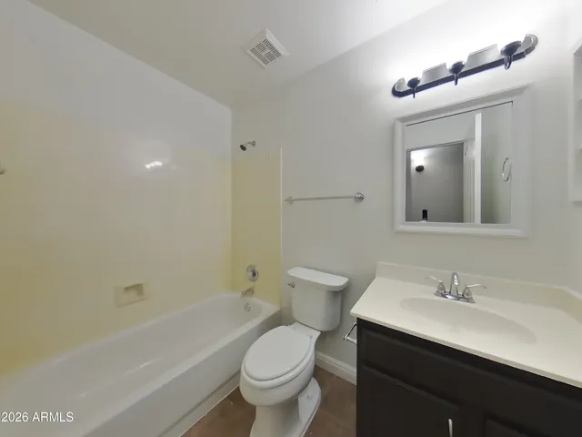 a view of a room with wooden floor and brick walls