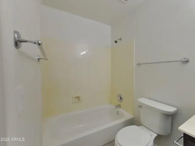 a bathroom with a sink toilet vanity and bathtub