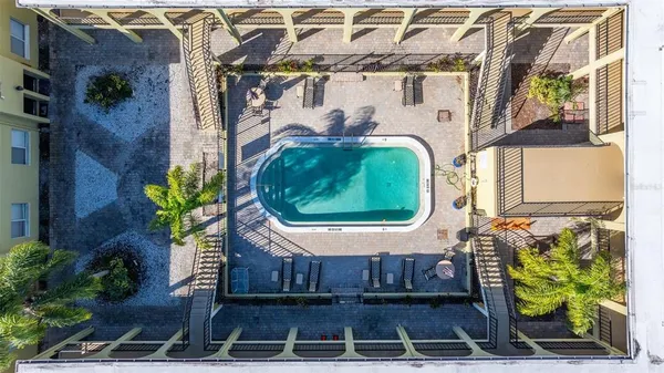 an aerial view of a house with a yard and potted plants