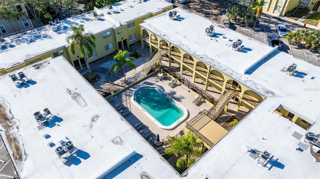 3206 West Azeele Street, Unit 128 Tampa, FL 33609 - Photo 12 of 18 an aerial view of a house with a yard and potted plants