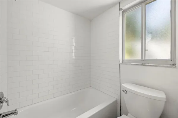 a bath tub sitting next to a white toilet
