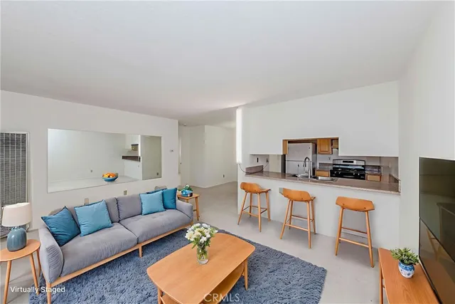 a living room with furniture a rug and a flat screen tv