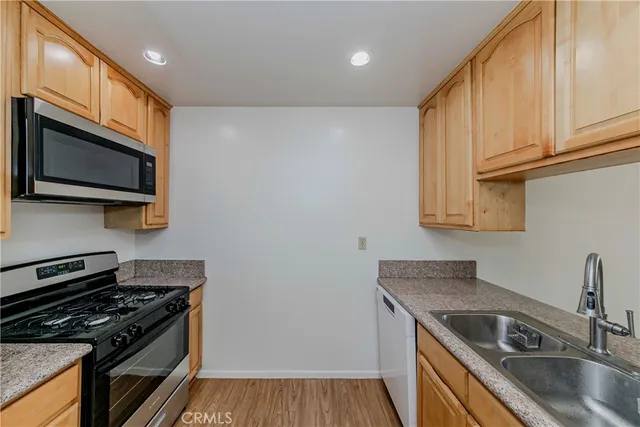 a kitchen that has a sink and a stove