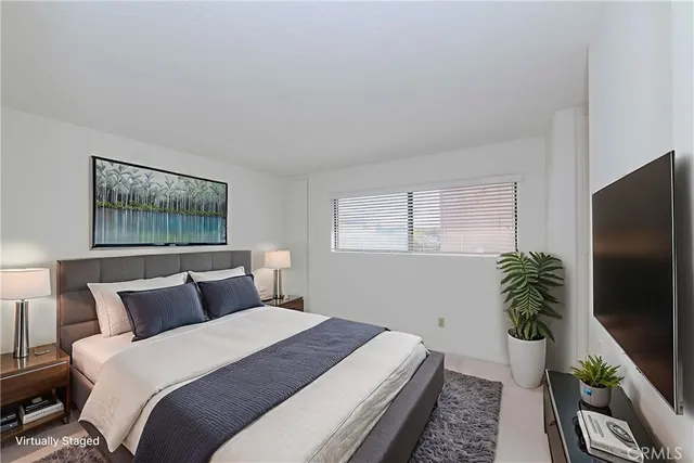 a bedroom with a bed potted plant with the window