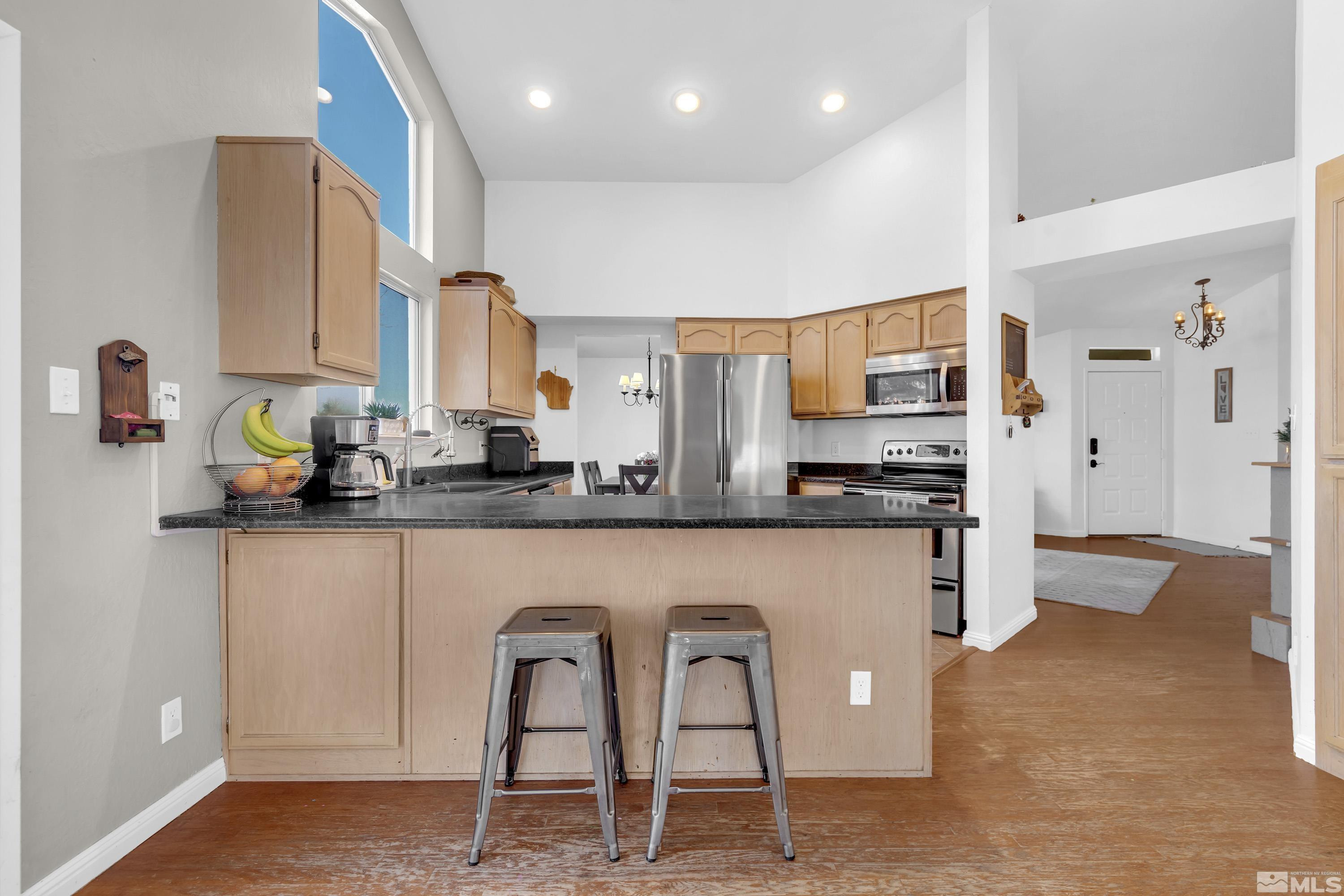 1121 Shadelands Court Reno, NV 89523 - Photo 11 of 38 a kitchen with stainless steel appliances granite countertop a refrigerator and a stove top oven