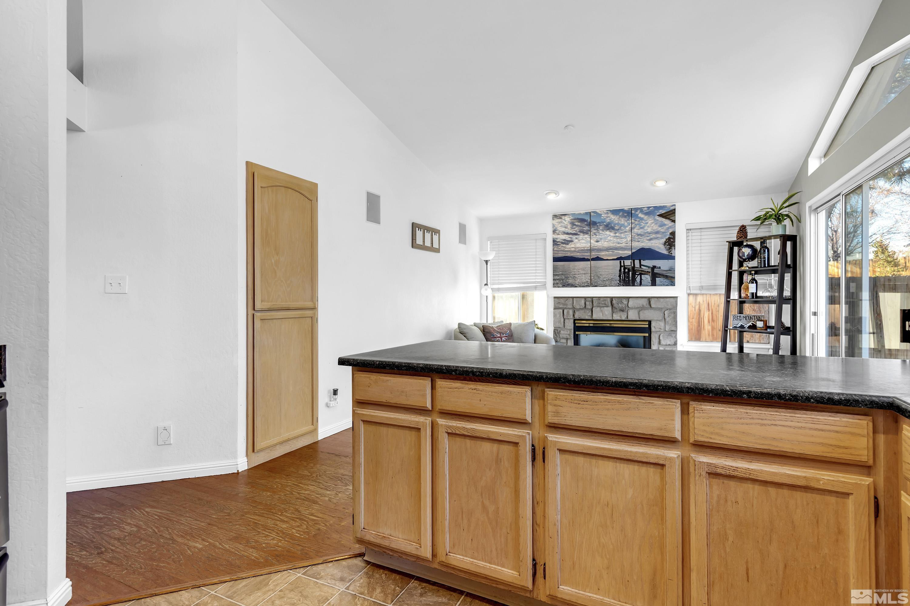 1121 Shadelands Court Reno, NV 89523 - Photo 14 of 38 a kitchen with stainless steel appliances granite countertop a sink and a wooden cabinets