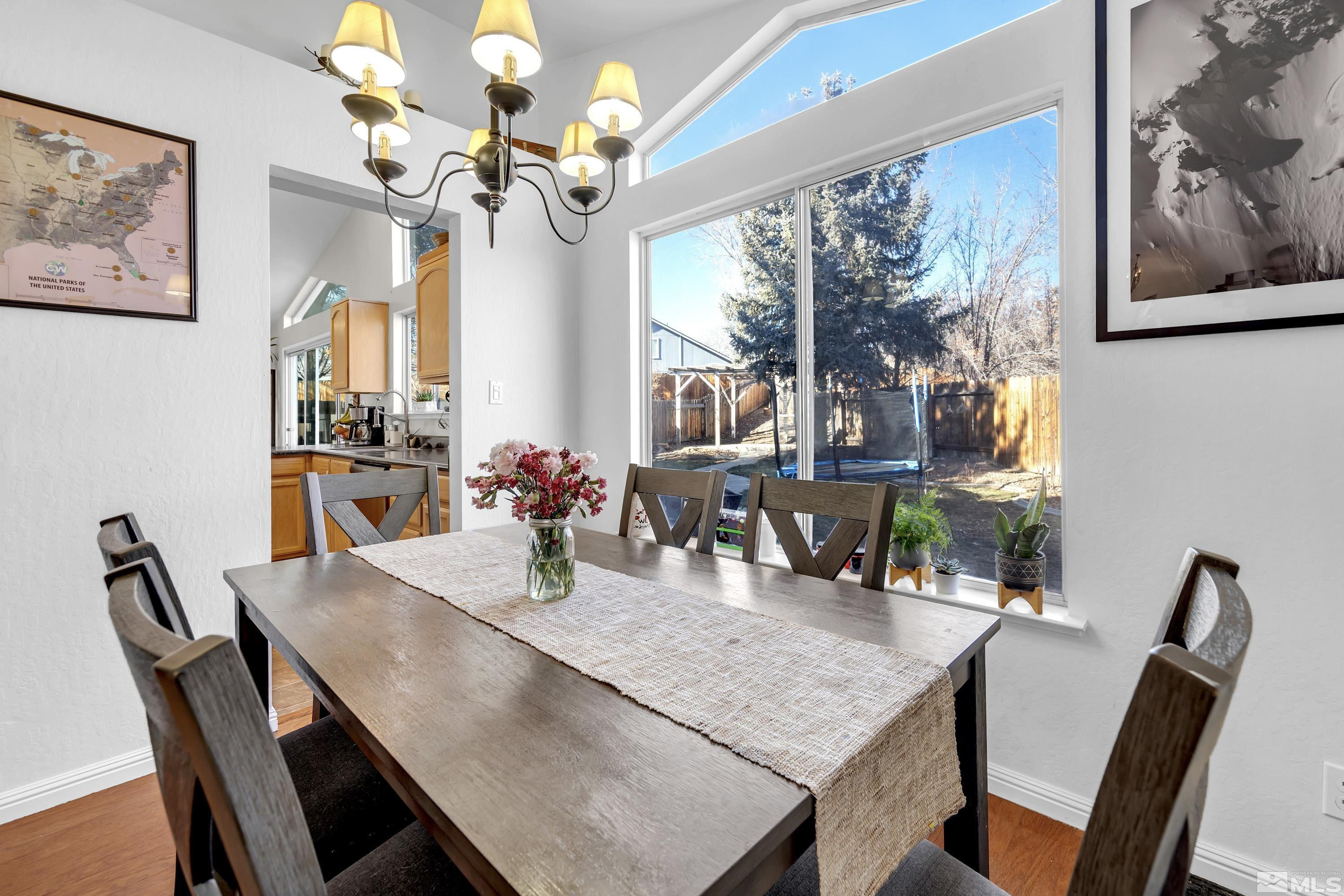 1121 Shadelands Court Reno, NV 89523 - Photo 8 of 38 a view of a dining room with furniture a chandelier and wooden floor