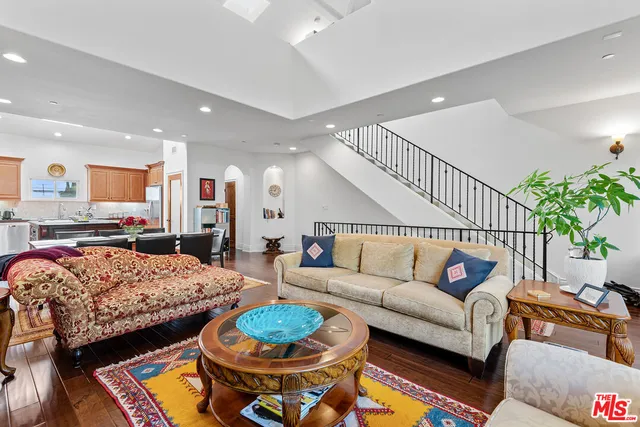 a living room with furniture and kitchen view