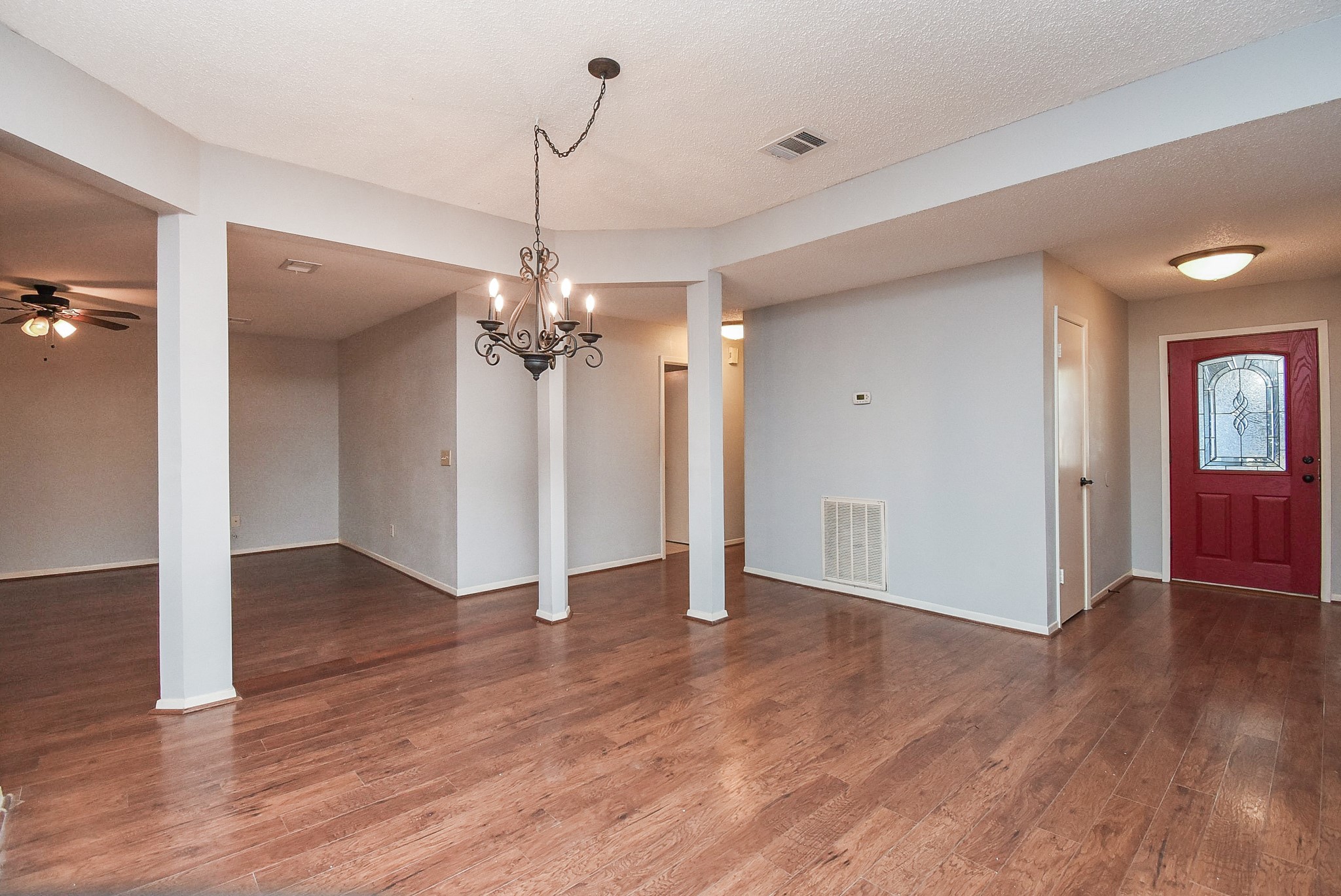 9107 Wallingham Court Spring, TX 77379 - Photo 4 of 25 a view of an empty room with wooden floor and a ceiling fan