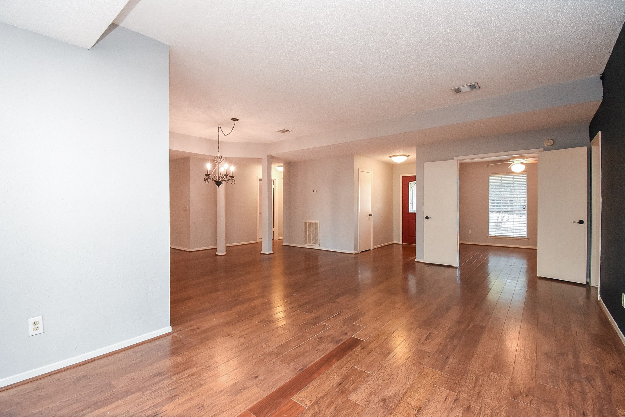 9107 Wallingham Court Spring, TX 77379 - Photo 5 of 25 a view of a room with wooden floor and windows