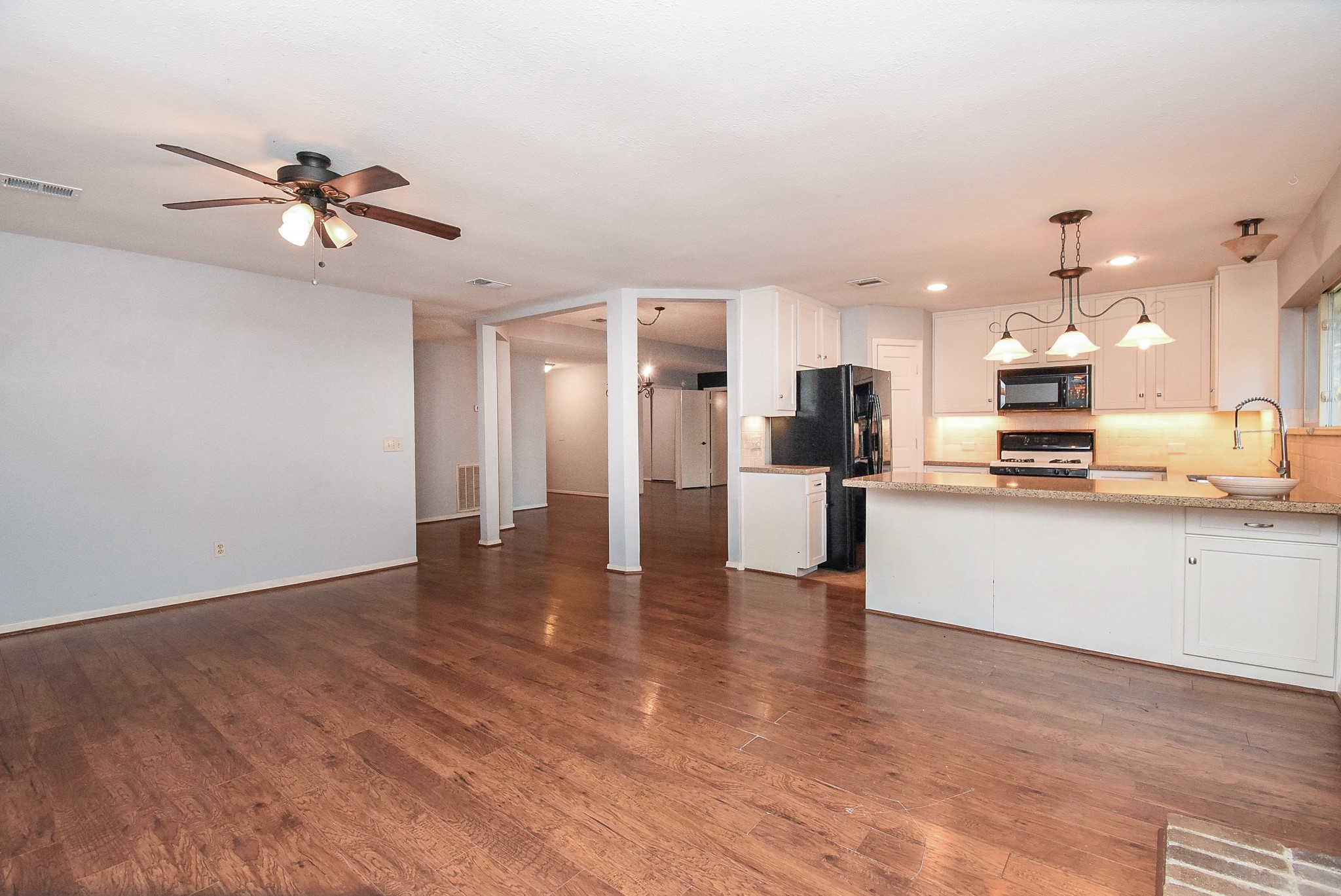 9107 Wallingham Court Spring, TX 77379 - Photo 9 of 25 a view of kitchen with refrigerator microwave and stove