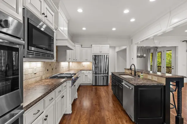 a kitchen with stainless steel appliances a sink and cabinets