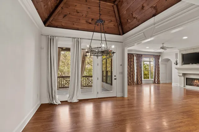 a view of a room with wooden floor and chandelier