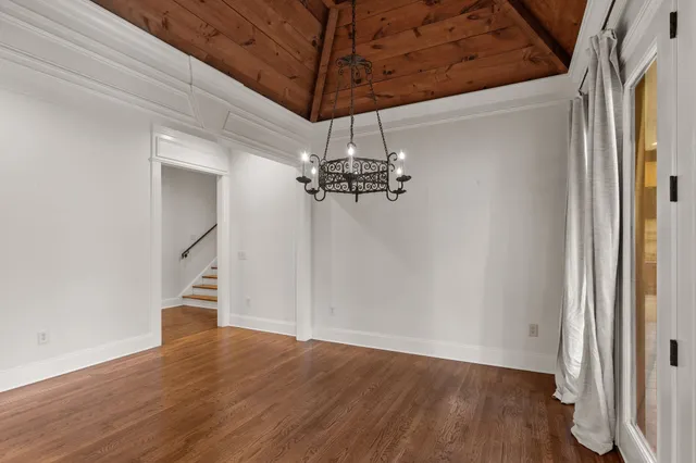 a view of a livingroom with furniture fireplace hardwood floor and windows
