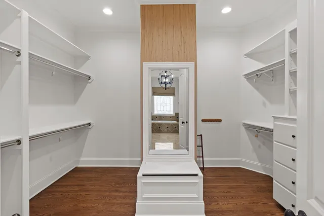 a view of walk in closet with empty racks