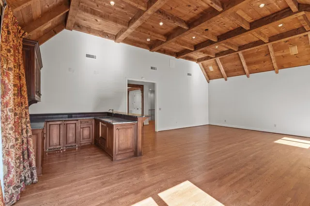 a kitchen with granite countertop white cabinets and stainless steel appliances