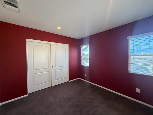 an empty room with closet area