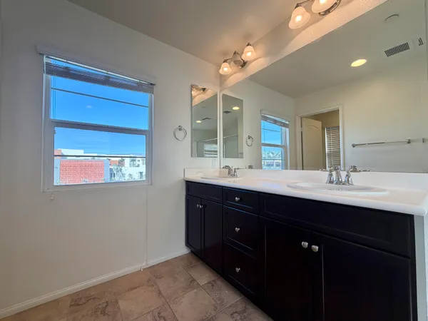 a bathroom with a sink double vanity and a mirror