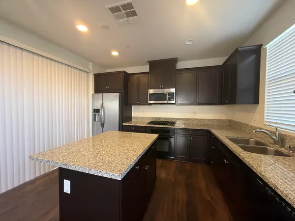 a kitchen with a sink stove and refrigerator