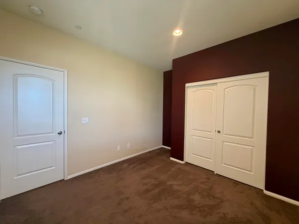 an empty room with closet area