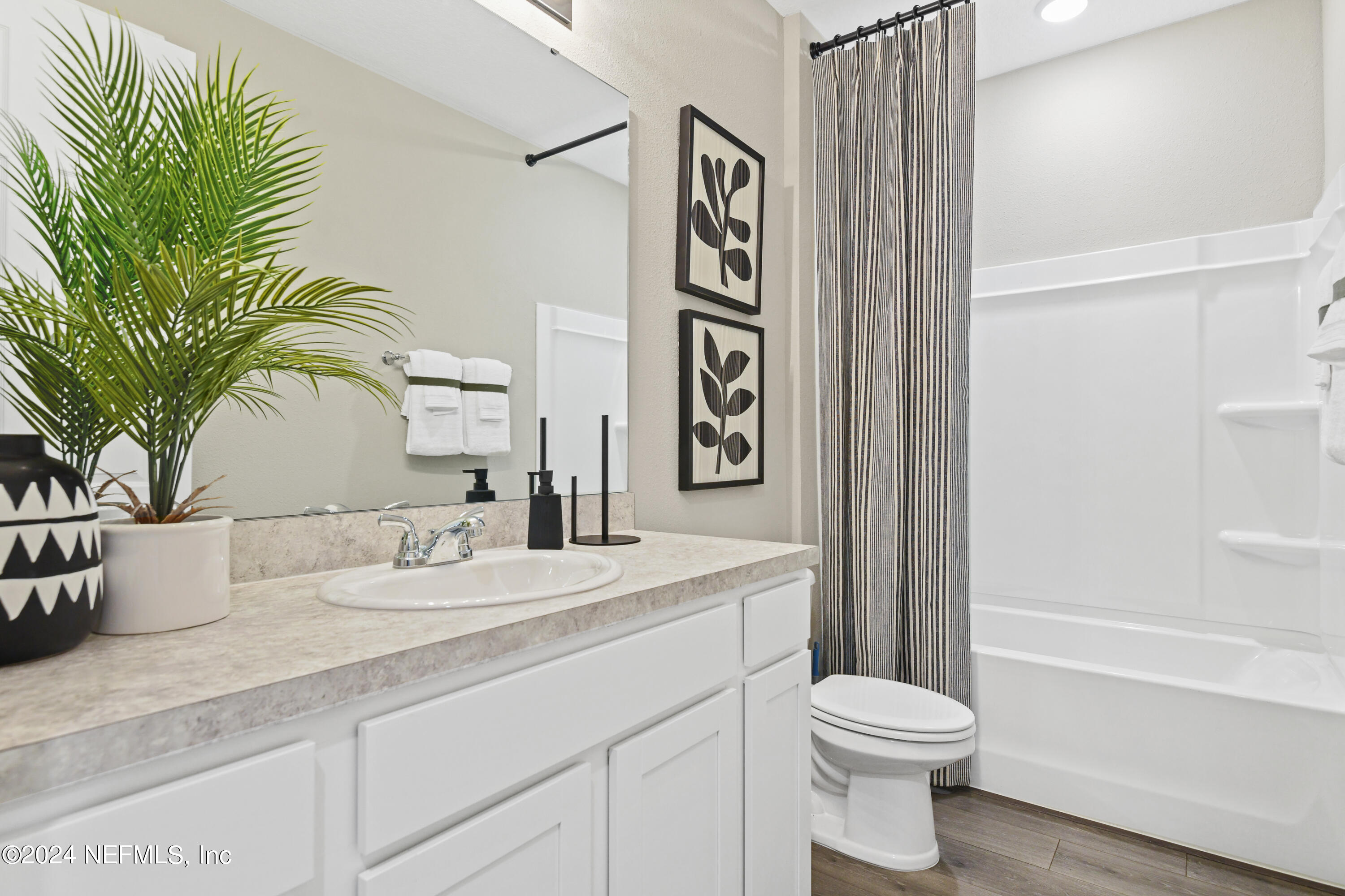 333 Cedar Elm Way St. Augustine, FL 32092 - Photo 15 of 24 a bathroom with a toilet sink and mirror