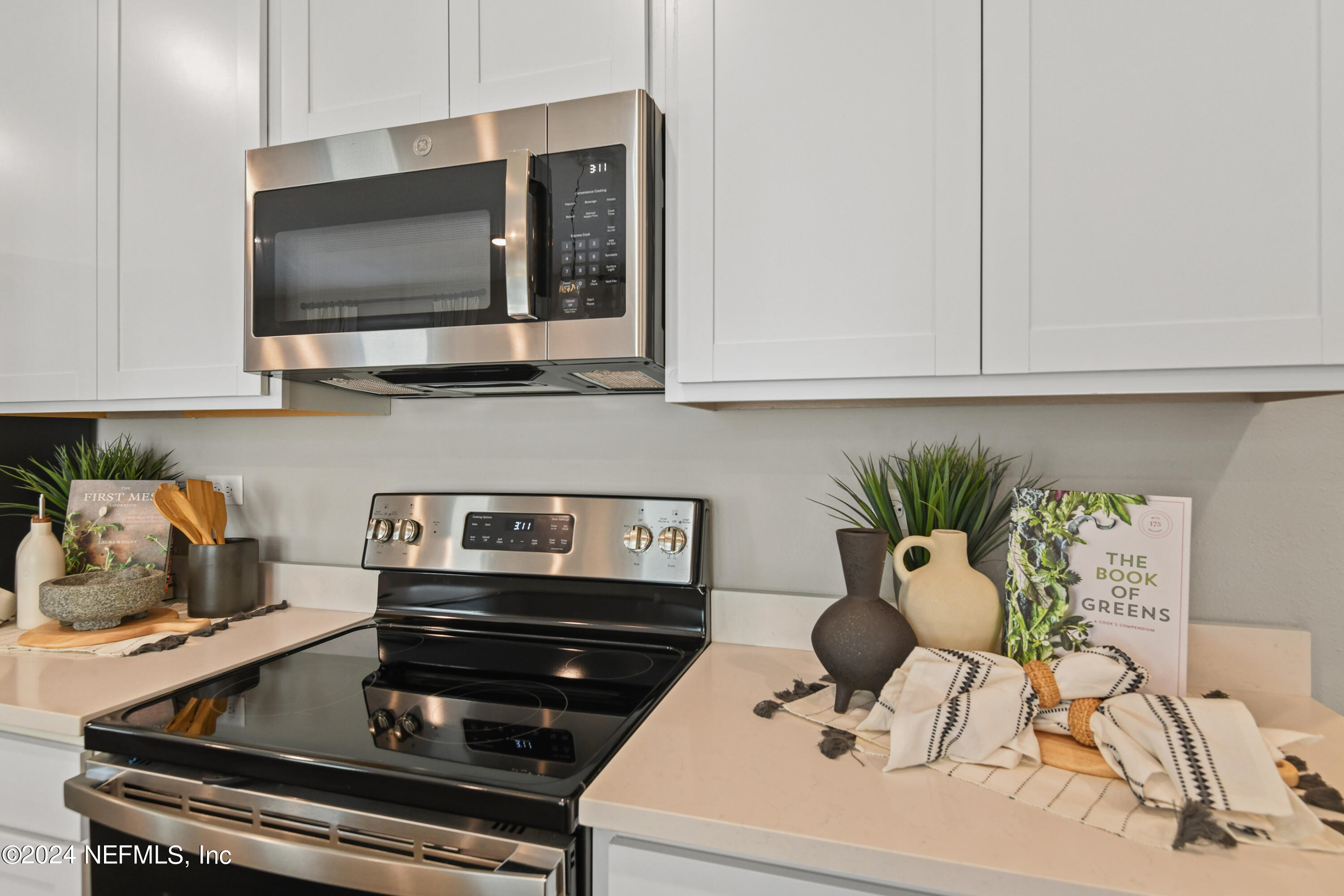 333 Cedar Elm Way St. Augustine, FL 32092 - Photo 6 of 24 a kitchen with a stove and a microwave