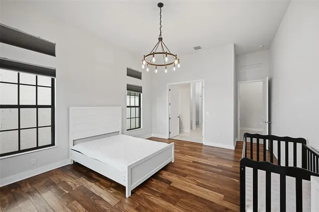 a living room with a bed furniture and next to a window