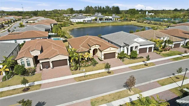 an aerial view of residential houses with outdoor space and river