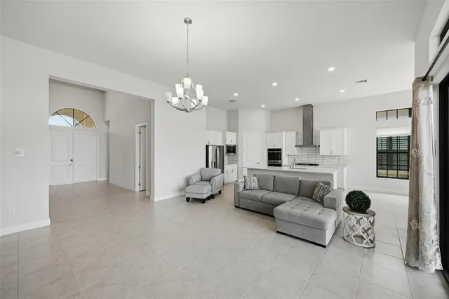 a living room with furniture and kitchen view