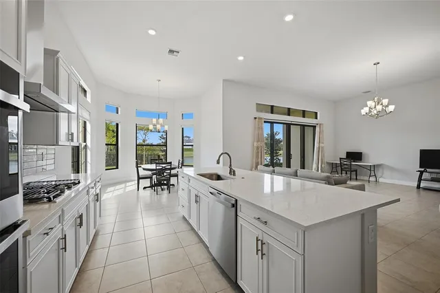 a large dining hall with stainless steel appliances granite countertop a lot of counter space and a dining table